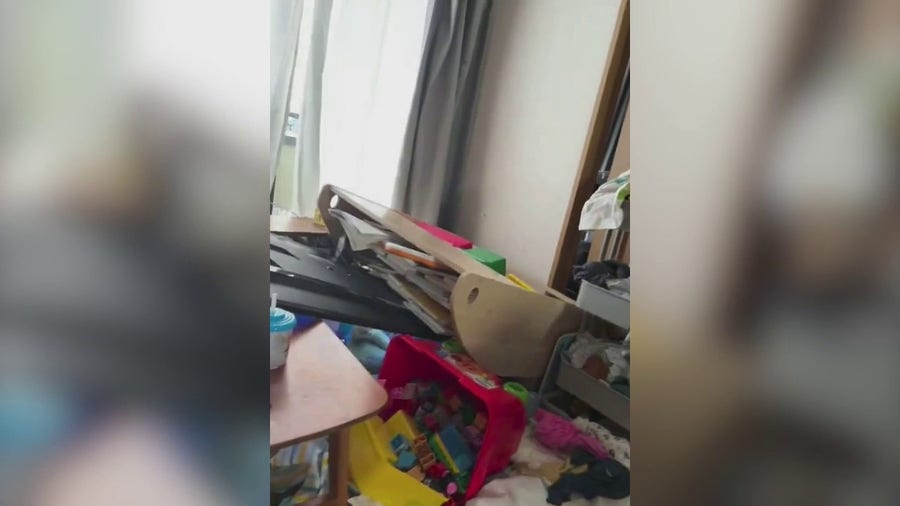 Child cries as power of Japanese earthquake felt in family Home