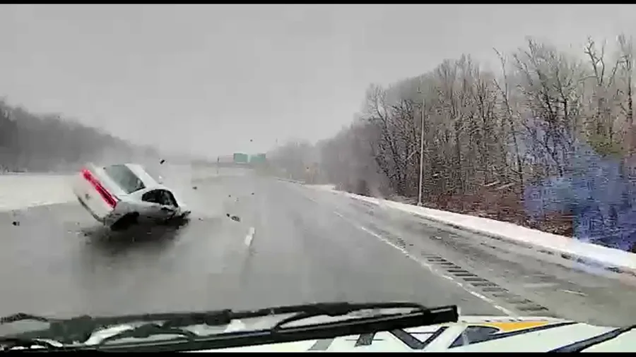 Massachusetts ambulance narrowly avoids being hit by rolling car during nor'easter