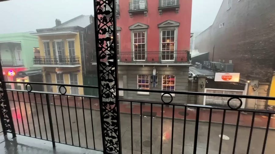 Torrential rains fall along New Orleans' Burbon Street on Wednesday morning