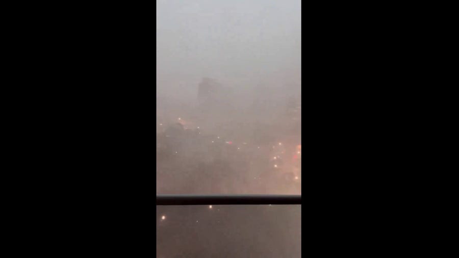 Debris seen in air over downtown Houston during thunderstorm