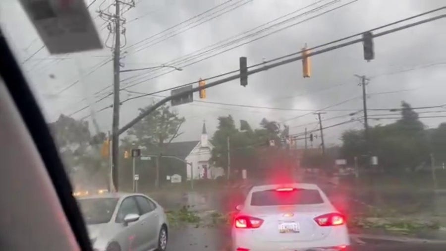 Drivers maneuver through flying debris in Maryland during tornado-warned storm