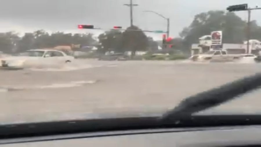 Cars plow through flash flood waters in Las Vegas, New Mexico