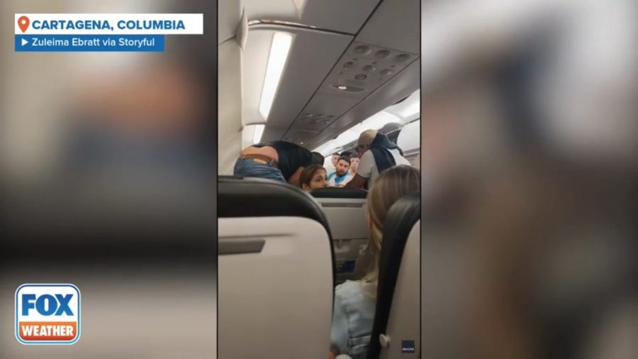 Airplane passengers pray as severe thunderstorm causes turbulence