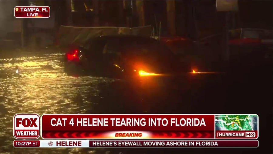 Watch: Tampa residents push car into Hurricane Helene floodwater