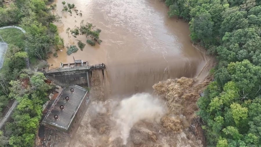 Swollen river pours over Tennessee' Nolichucky River Dam.