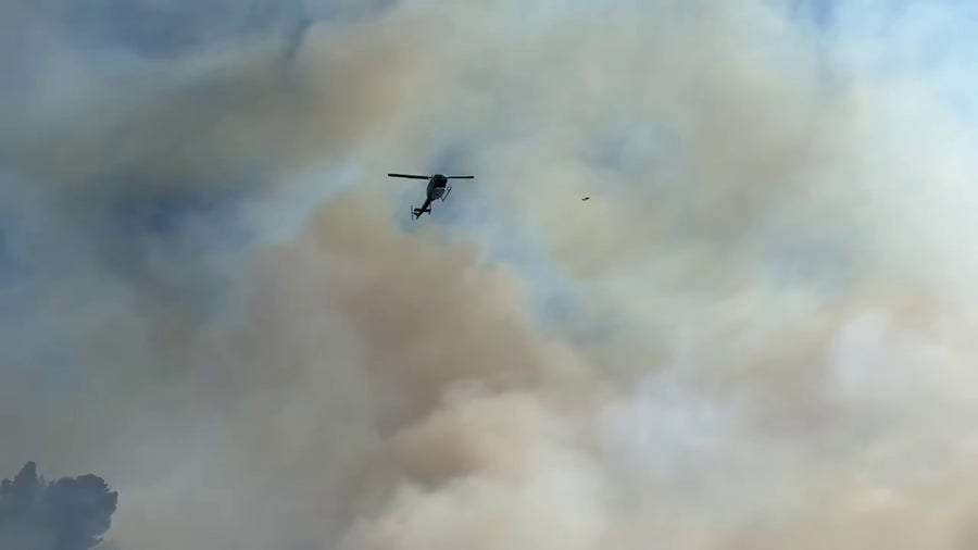 Firefighters prepare to drop water on Montezuma Fire in San Diego