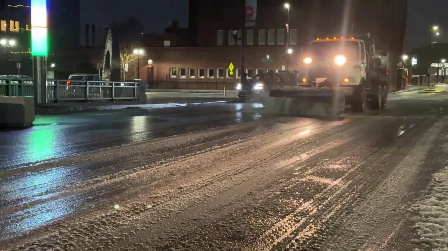 Plow works to clear ice from roads in Cedar Rapids, Iowa