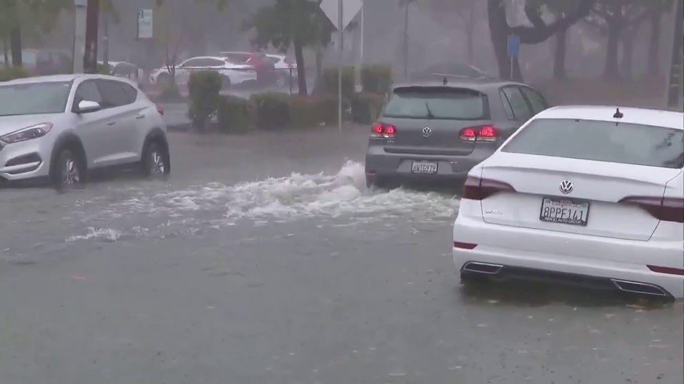 Cars were seen driving over flooded roads in San Rafael, California on Sunday.