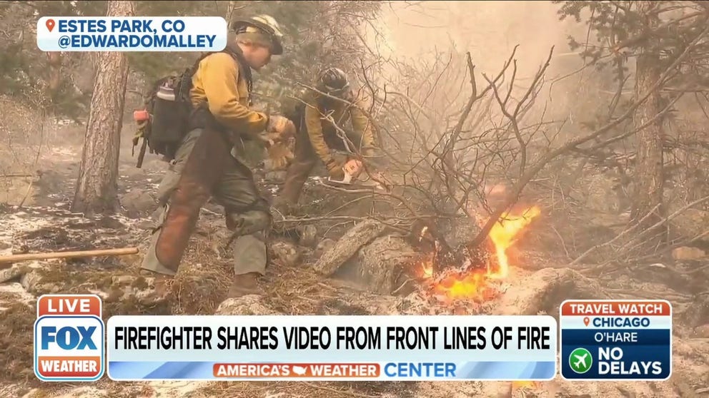 Video shows firemen inside the Estes Park, Colorado blaze clearing out brush and debris to prevent further spread.