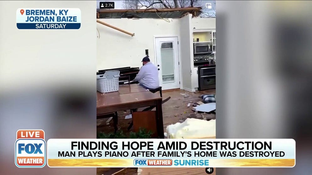 A man plays the piano after his family's home was destroyed by the tornado on Friday night in Bremen, Kentucky. 