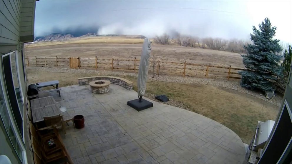 A rain and snow squall moved into the Denver area on Dec.15, with the National Weather Service forecasting wind gusts of up to 100 mph. Timelapse video filmed by Jeff Dion in Colorado shows dramatic clouds sweeping over his backyard and snow falling. 