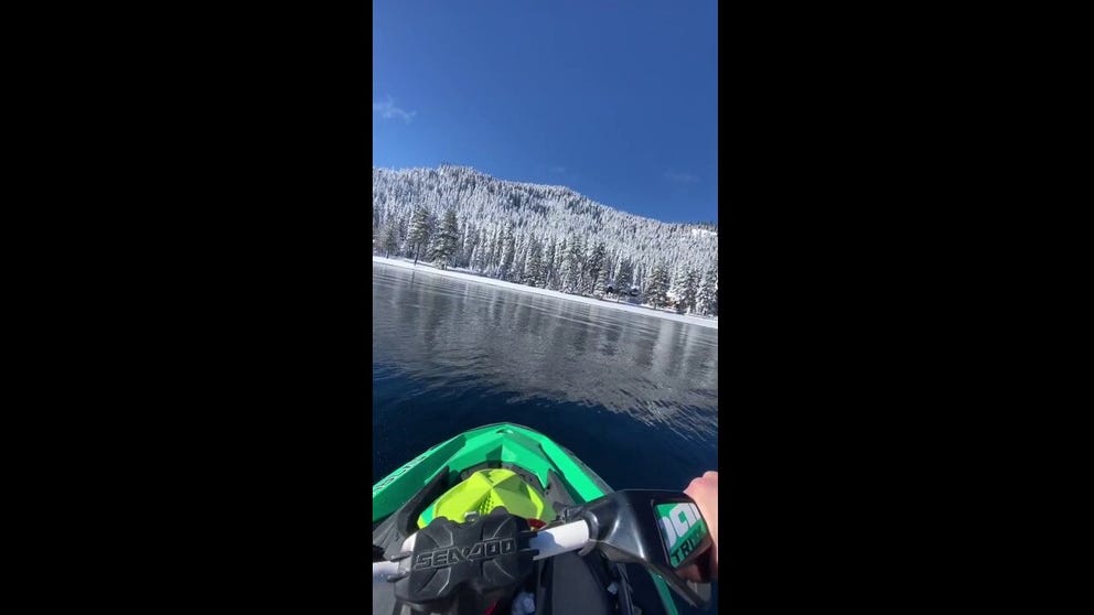 A volunteer on a jet ski takes in the wintry view before helping to pick up trash.