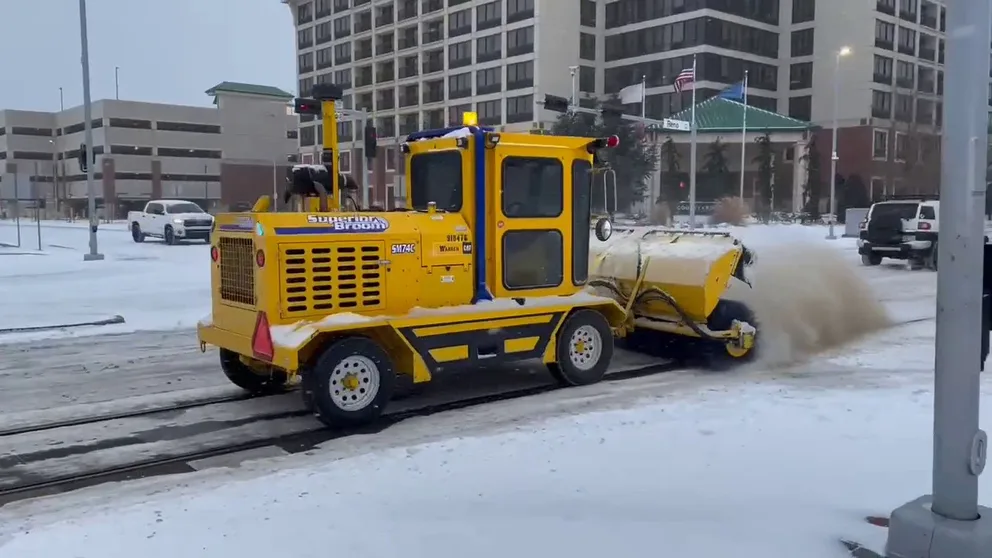Crews work to keep the tracks clear for the streetcar in Oklahoma City, Oklahoma, on Feb. 3, 2022. The Oklahoma Department of Transportation said travel in most parts of the state is strongly discouraged as more counties are affected by the low temperatures, new rounds of winter precipitation and blowing snow. 