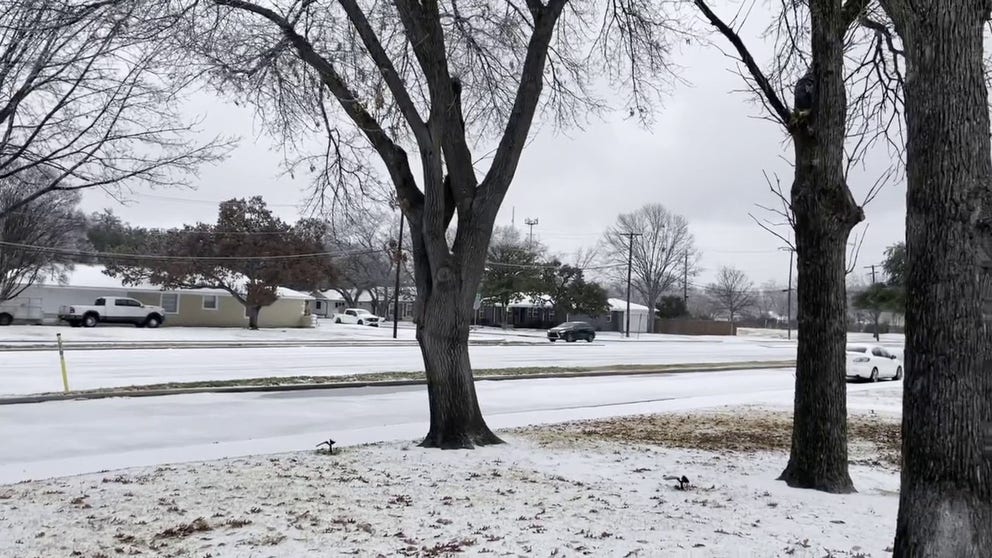 Snow and ice cover the ground in a Dallas neighborhood on Thursday.