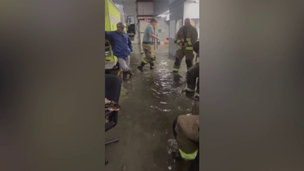 Footage released by the Monroeville Fire Department shows firefighters and engines surrounded by floodwater. (Video: Monroe Fire and Rescue Department via Storyful)