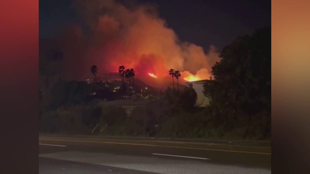 Wind-fueled flames of the Emerald Fire spread quickly across Orange County, California pre-dawn near Laguna Beach Thursday.