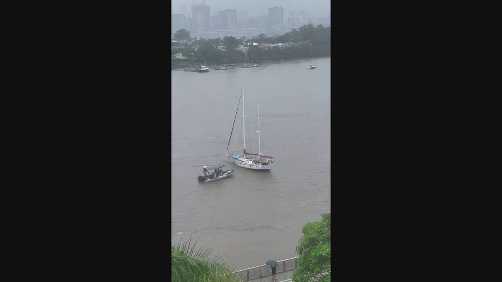 Two boats broke free of their moorings and drifted down the Brisbane River due to flash flooding.