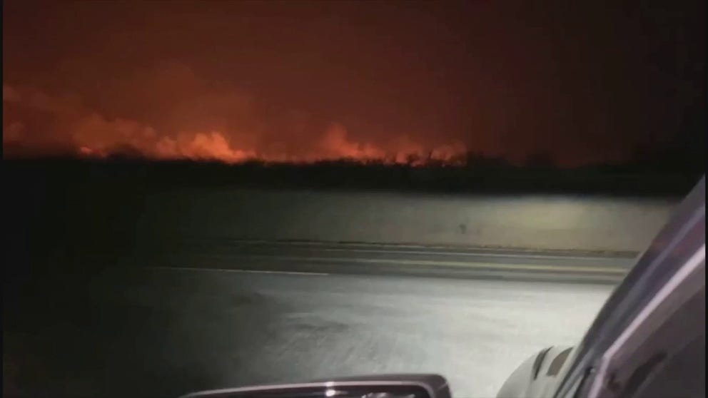 Firefighters battled a group of wildfires in Eastland County, Texas, as officials said on March 19 that the blaze had grown to over 45,000 acres and was just 15% contained. Tyler Schaffner said he recorded this video between Eastland city and Desdemona at around 9 p.m. on March 18.