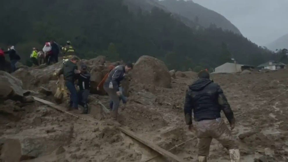 Survivors of Sunday's landslides around Cuenca, Ecuador frantically search through the mud for others.