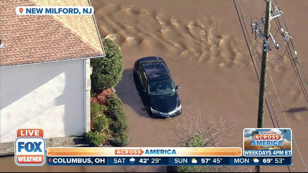 Flooding has residents evacuate from homes in New Milford, New Jersey. Roads were under several inches of water. 