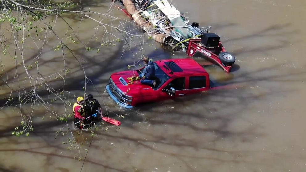 Two men were rescued Thursday in northwest Alabama after their pickup was swept from the road by rising floodwaters.