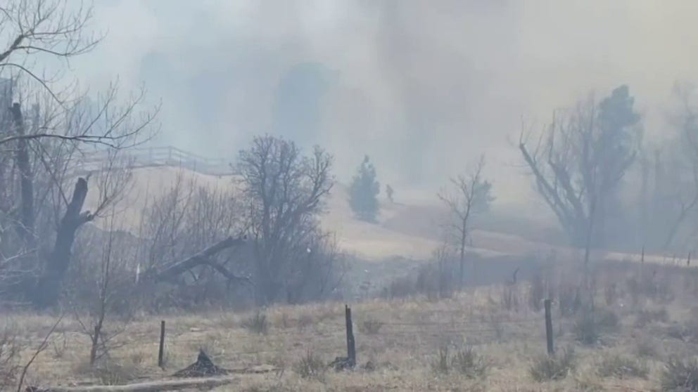 Strong winds drive smoke from Colorado Springs wildfire. Fire crews say no structures have been lost.