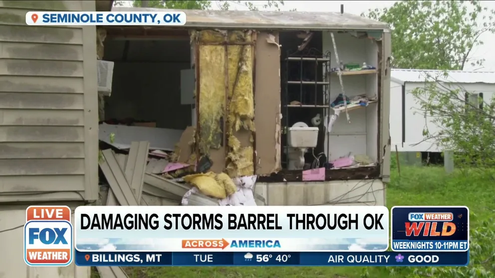FOX Weather’s Hunter Davis shows damage in Seminole, Oklahoma where a tornado-warned storm damaged mobile homes and uprooted trees. 