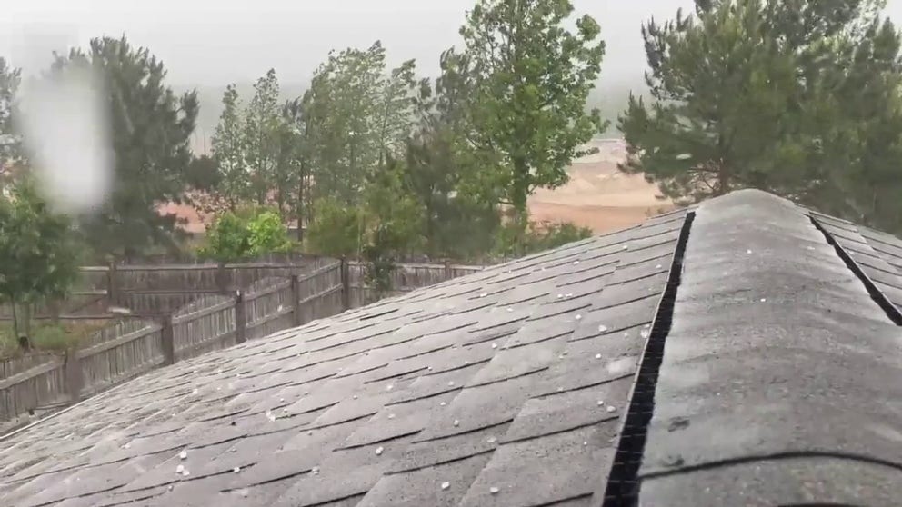 Video shows hail bouncing off the roof of a home in Wake Forest, North Carolina on Friday.