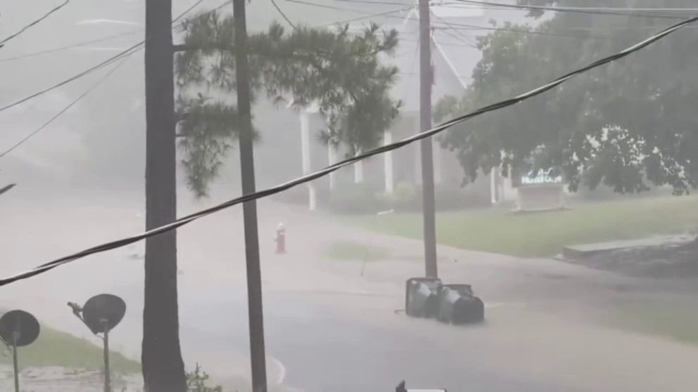 Video captures flooding in Burlington, North Carolina on Monday. Trash cans are seen floating down a roadway. (Video: Kate Gunther Bowers via Storyful)