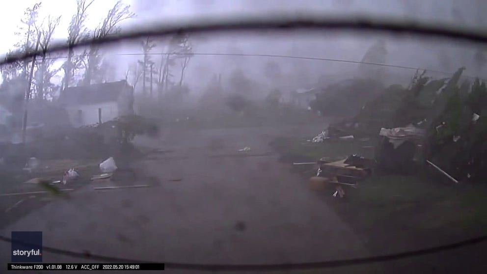 Dash cam video from a car in a garage shows a deadly EF-3 tornado tearing down a street in Gaylord, Michigan.