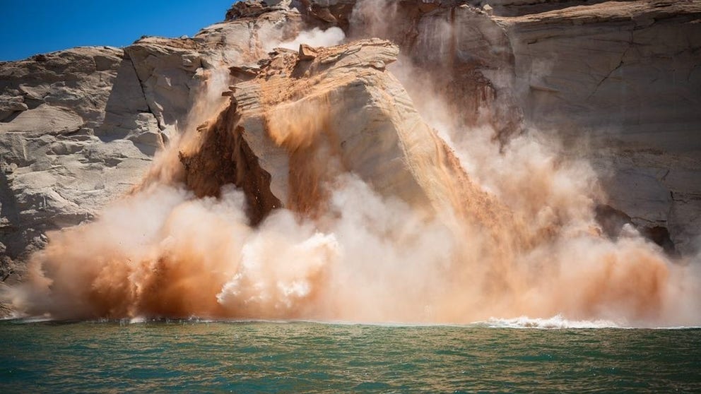 A massive cliff broke off and tumbled into Lake Powell Monday, sending up a towering plume of water and debris. (Video courtesy: Steve Carter)