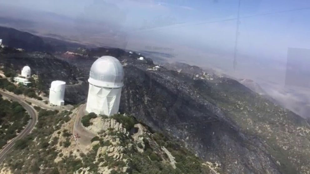 Video from the Arizona Bureau of Land Management shows the telescopes and science buildings are still standing at the Kitt Peak National Observatory amid an ongoing wildfire.