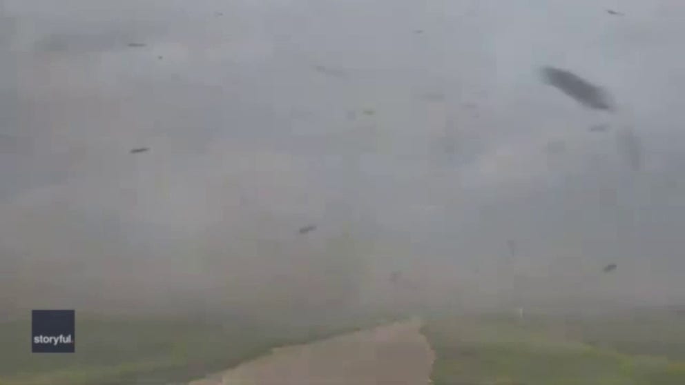 A storm chaser gets caught up in gustnado-like winds in Wild Rice, North Dakota during a severe storm on Monday. (Video: John Homenuk via Storyful)
