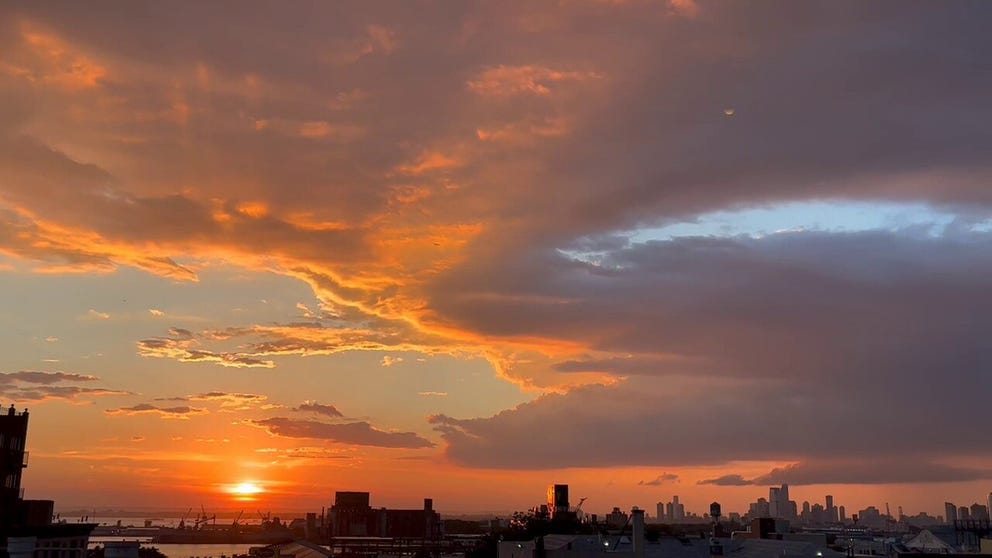Video taken from Sunset Park, Brooklyn captures a beautiful sunset over the New York City skyline.  