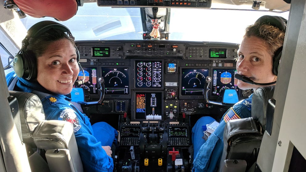 Commander Rebecca Waddington explains the work of NOAA Hurricane Hunters like herself. One aspect of their research involves releasing devices called "dropsondes" into hurricanes to gather data about the storms. 