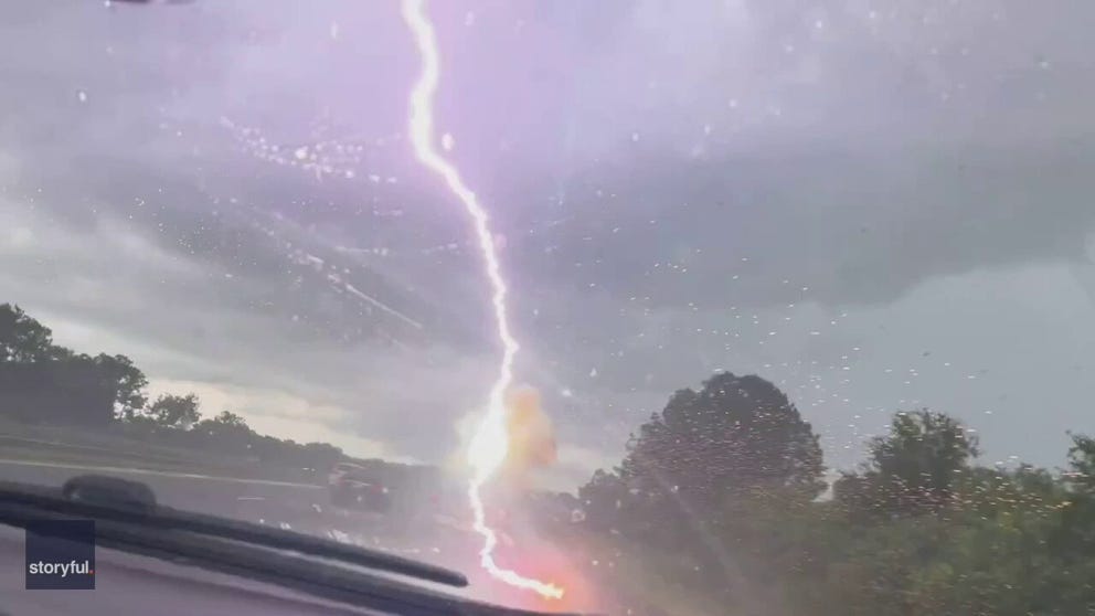 A woman captured an explosive lightning strike hitting her husband's truck on the highway in Tampa, Florida on July 1.
