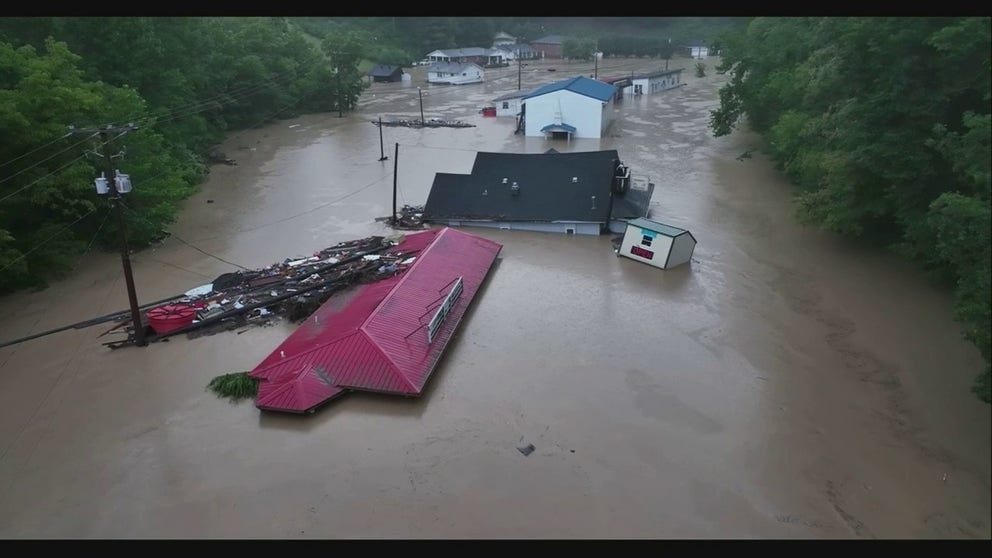 Drone video shows homes and cars underwater from flooding in Hindman, KY on Thursday. 