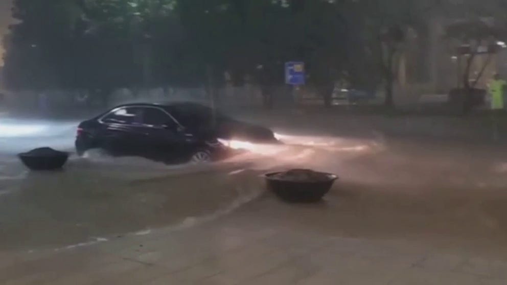 Torrential rain is bringing deadly flash flooding to South Korea. Video shows cars stranded in the floodwater. 