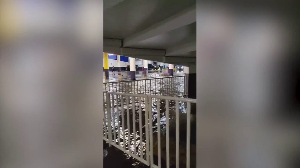 Video shows a Las Vegas parking garage flooding amid intense rainfall on Thursday. 