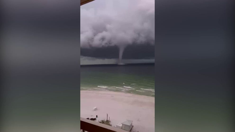 Video captures a large waterspout moving just off a beach in Destin, Florida. (@Matt_Beach9/Twitter)