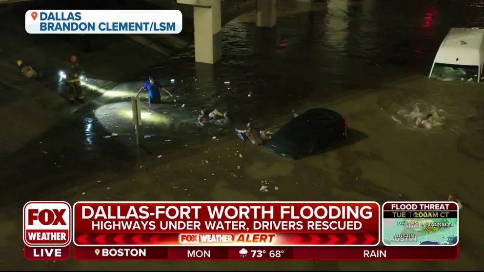 Watch video of drivers swimming from their cars, quickly sinking in floodwaters at an underpass. Then, FOX Weather's Robert Ray was reporter turned rescuer when he carried a woman to safety.