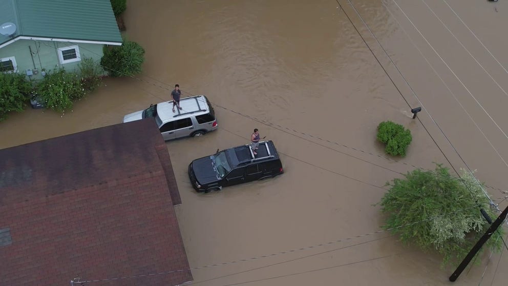 Drone video shows major flooding leaving residents stranded in Canton, Mississippi, with some standing on top of their vehicles. 
