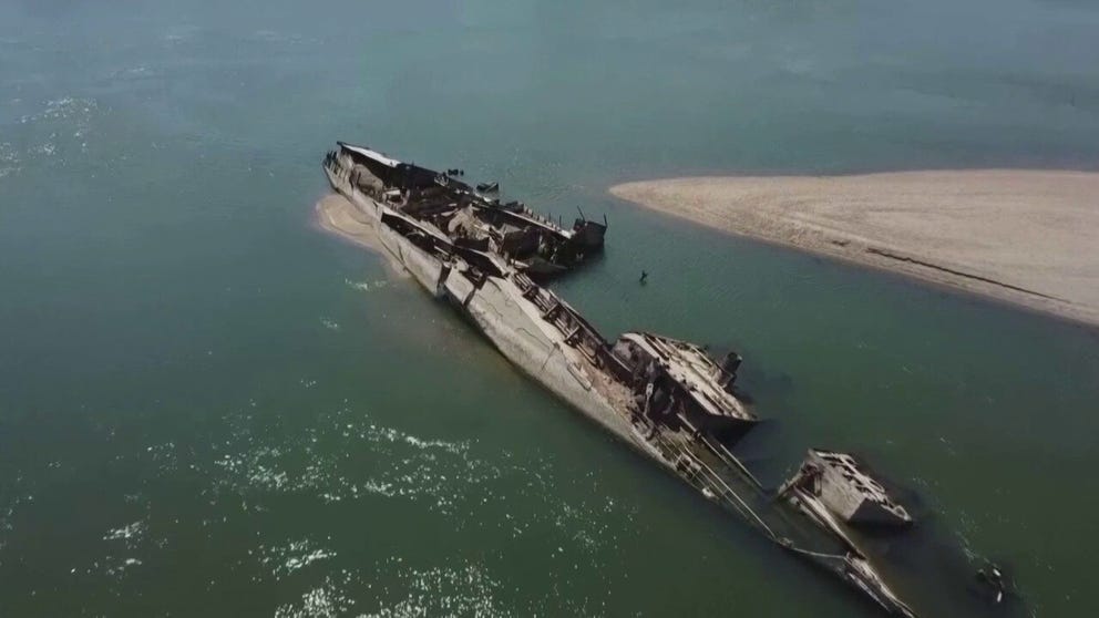 Extremely low water levels due to drought on the Danube River, uncovered World War II warships on the sandy bottom.