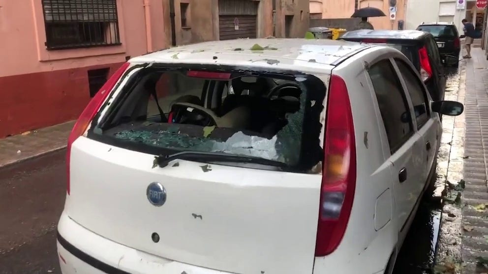 Footage recorded by Pere Mauny on Tuesday shows hailstones ricocheting off roofs and gutters and smashing on the ground in La Bisbal d'Emporda. Parked cars can also be seen with windows dented and smashed.
