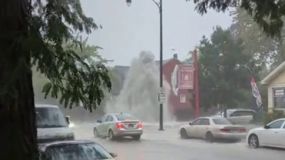 A jet of water shot into the air over a street in Chicago after heavy rain in the area on Sunday.
