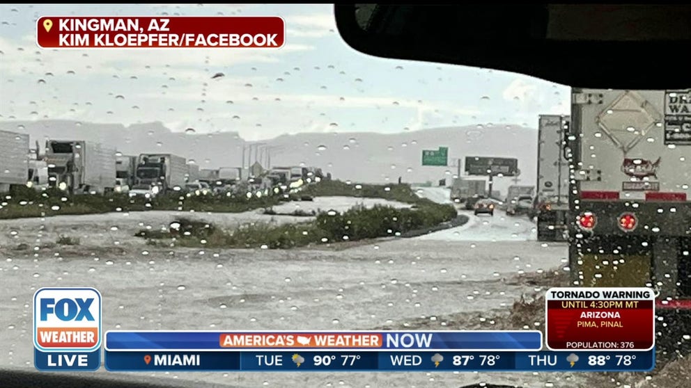 Traffic came to complete stop after vehicles were submerged in flash flooding Monday afternoon in Kingman, Arizona. 