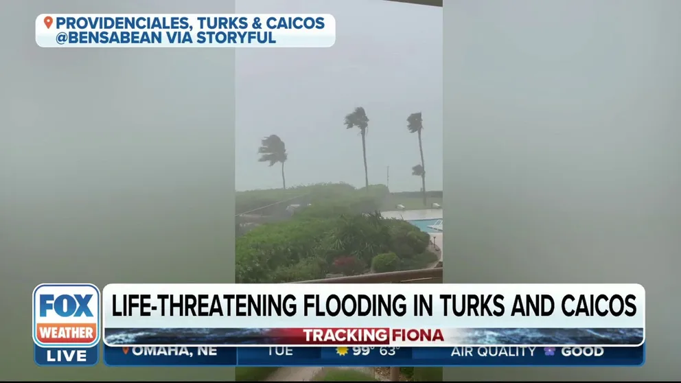 Hurricane Fiona lashes the shores of Providenciales, an island in the Turks and Caicos. Gusty winds are seen whipping palm trees.