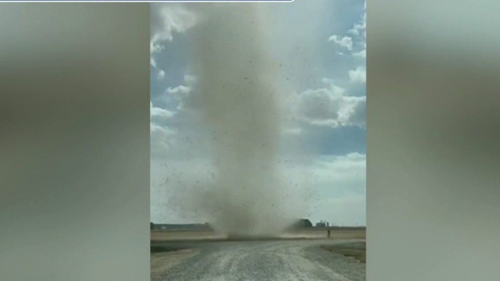 Video by Matt Conatser shows the towering dust devil quickly move across the dirt picking up debris.