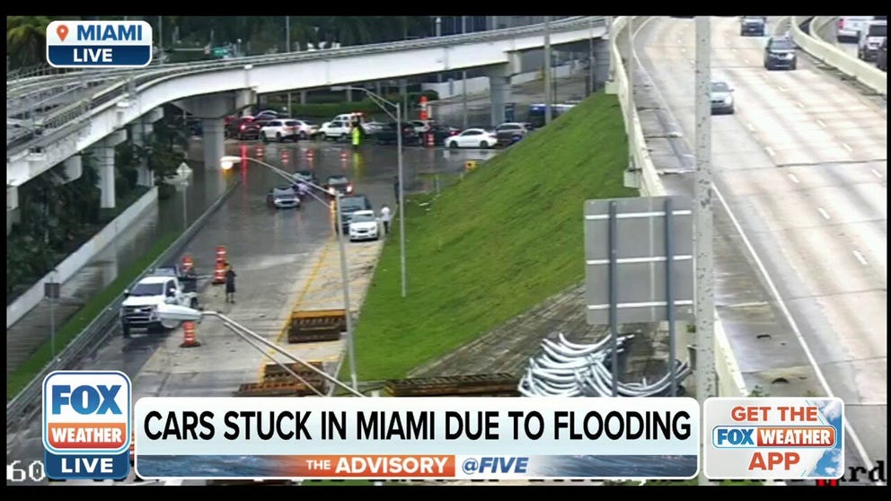 Afternoon commuters get stuck in floodwaters by an I-395 exit ramp in Miami, Florida. 