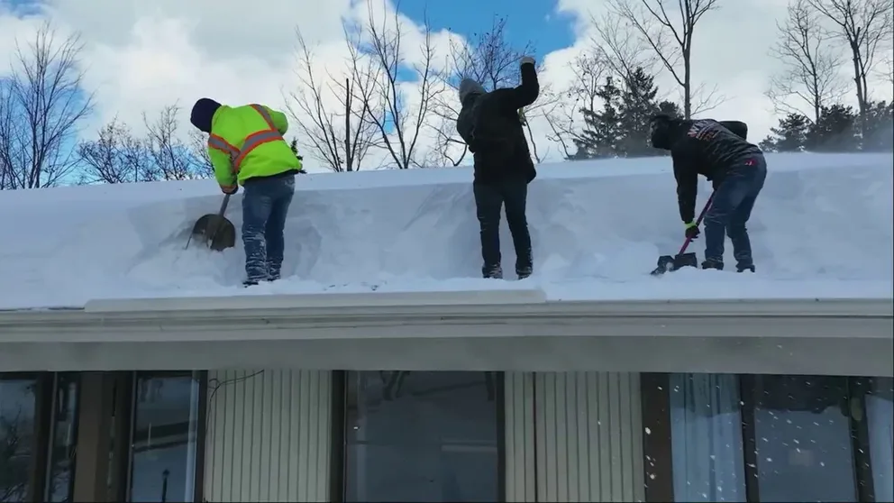 Homeowners and apartment maintenance workers shovel the record snowfall in Orchard Park, New York off roofs afraid of collapse under the weight. Orchard Park received a total of 80 inches of snow.